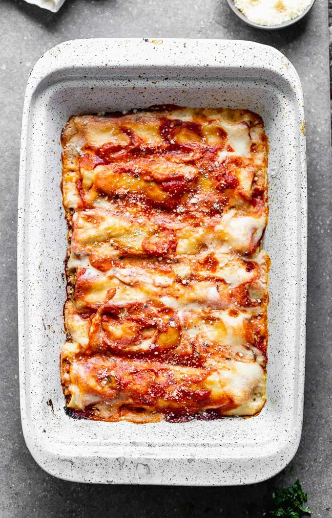 This Meat Cannelloni with Creamy Tomato Béchamel has homemade pasta is encased around a melt-in-your-mouth veal, pork, and chicken filling, it's covered in tomato sauce, creamy béchamel, and dusted with parmesan.