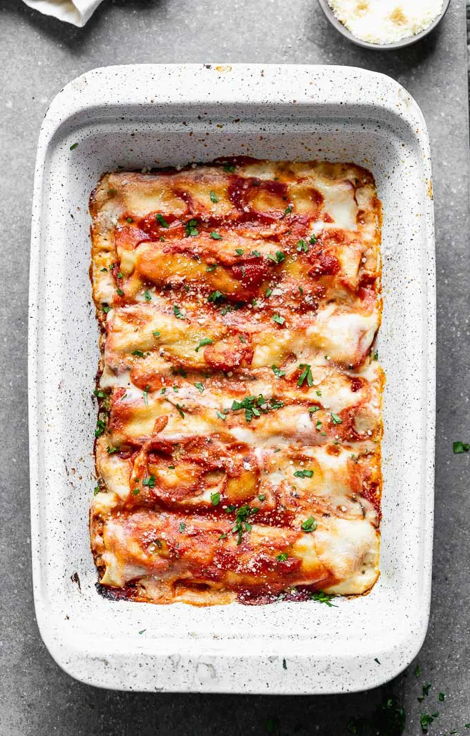 This Meat Cannelloni with Creamy Tomato Béchamel has homemade pasta is encased around a melt-in-your-mouth veal, pork, and chicken filling, it's covered in tomato sauce, creamy béchamel, and dusted with parmesan.