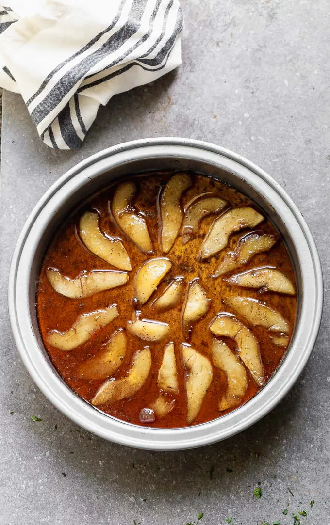 Arrange the pears in the bottom of a buttered baking pan.