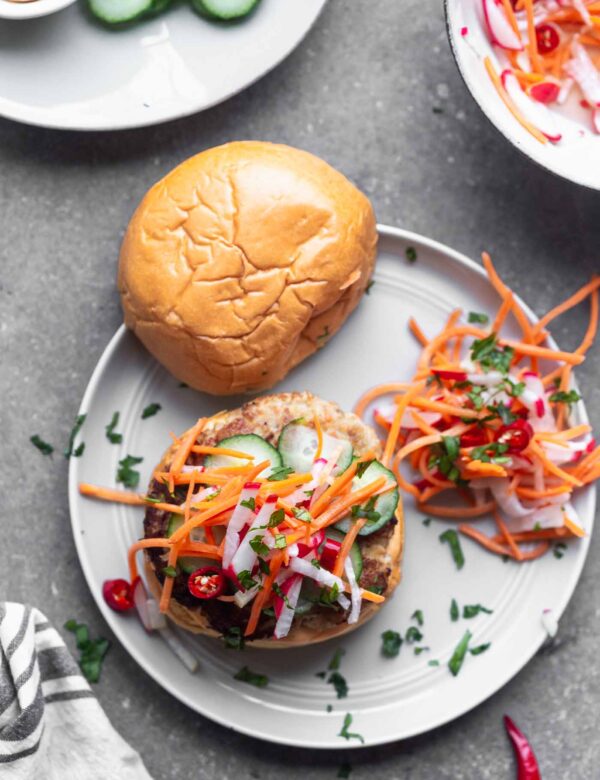 Bánh Mì Chicken Burgers are a burger take on a classic. A ground chicken patty is packed with all the flavors of a classic Bánh Mì sandwich, topped with sweet and spicy pickled veggies, a zippy sriracha mayo, and sandwiched between a toasted brioche bun.
