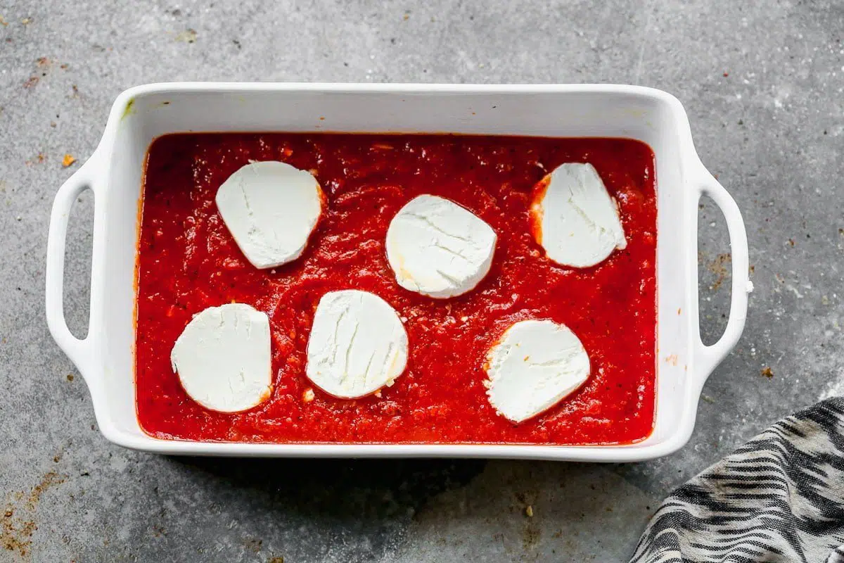 goat cheese on top of tomato sauce