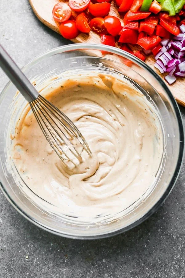 Whisk dressing ingredients together until smooth