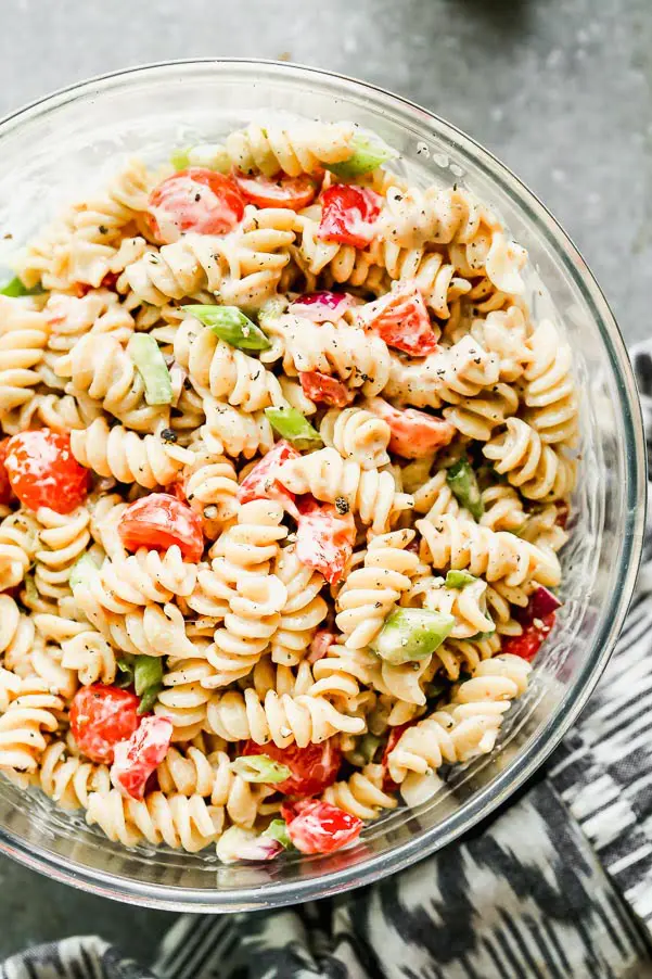 This is The BEST Creamy Pasta Salad you will ever make, promise. Thanks to one secret ingredient, this classic creamy pasta salad is infinitely flavorful. Throw in your favorite veggies, cook up your favorite pasta, and watch this easy pasta salad disappear.&nbsp;