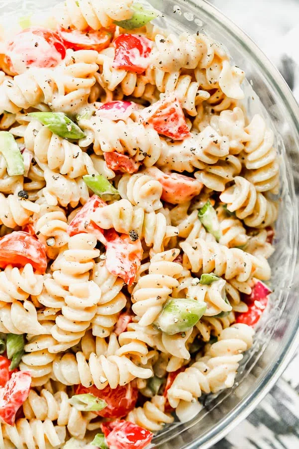 This is The BEST Creamy Pasta Salad you will ever make, promise. Thanks to one secret ingredient, this classic creamy pasta salad is infinitely flavorful. Throw in your favorite veggies, cook up your favorite pasta, and watch this easy pasta salad disappear.