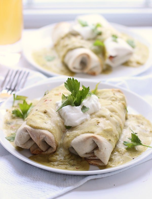 Fajita Burritos with Poblano, Jalapeno Cheddar and Green Chile Sour Cream Sauce via cookingforkeeps.com