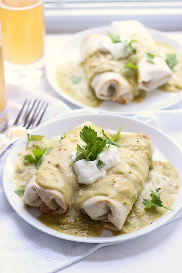 Fajita Burritos with Poblano, Jalapeno Cheddar and Green Chile Sour Cream Sauce via cookingforkeeps.com