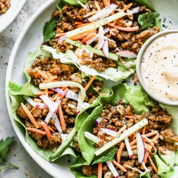 Let's take all of the flavors of a classic Banh Mi Sandwich deconstruct it and nestle everything into perfect little Vietnamese Lettuce Wraps. We will get crispy, salty ground pork, crisp veggies, with a sweet and spicy mayo drizzle in each drippy bite we take. And we will be happy. 