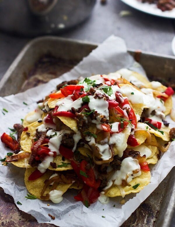 Italian Style Nachos - Layers of spicy italian sausage, roasted red peppers, fontina cheese and a creamy cheese sauce are the spin on a classic nacho!