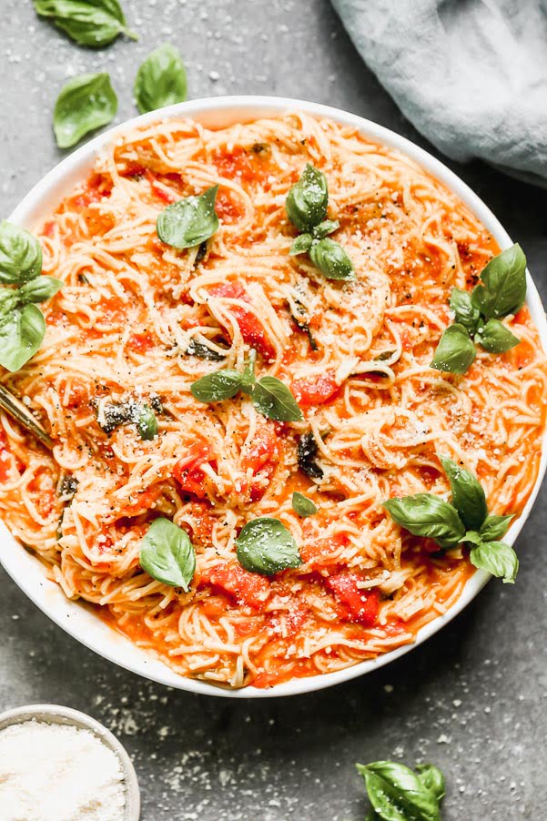 This One Pot Fresh Tomato Pasta is the perfect way to use up all your summer tomatoes! We cook down the tomatoes with an obscene amount of garlic, a little bit of sugar, and plenty of salt and then cook fresh pasta directly in the sauce. Finish it off with a handful of parmesan cheese, serve with a salad and this easy summer dinner is done.&nbsp;