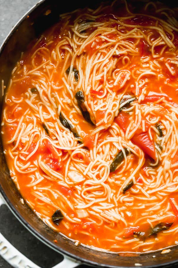Simmer pasta in tomato sauce 