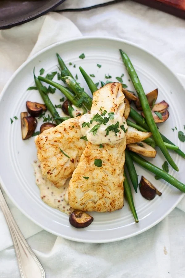 Brown Butter Seared Haddock with Mustard Cream Sauce - I promise, this will be your new favorite seafood dish! Super easy, minimal ingredients and comes together in under 30 minutes.