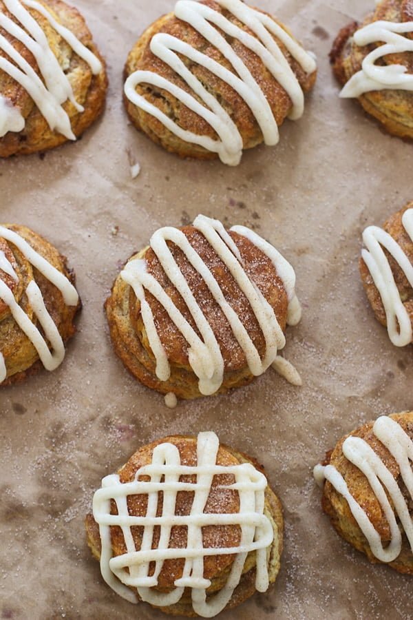 Cinnamon Roll Butterilk Biscuits - Super flaky layers of dough sprinkled with cinnamon and sugar and drenched in cream cheese frosting.