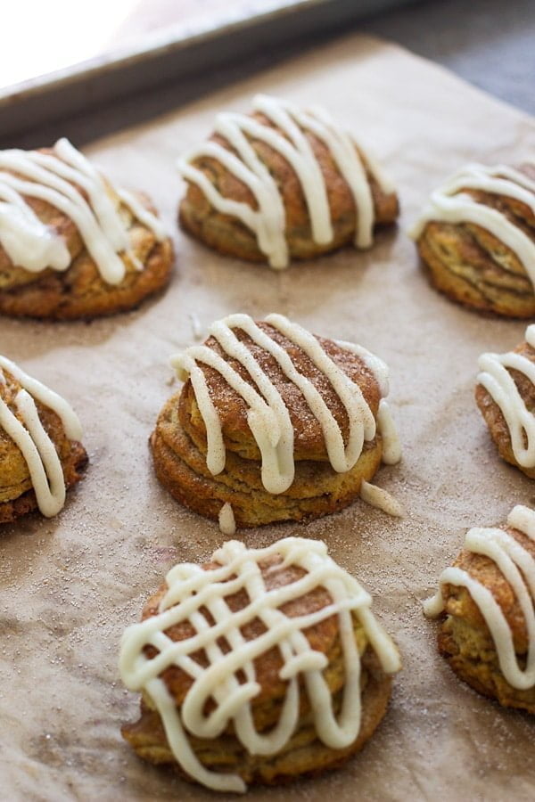 Cinnamon Roll Butterilk Biscuits - Super flaky layers of dough sprinkled with cinnamon and sugar and drenched in cream cheese frosting.