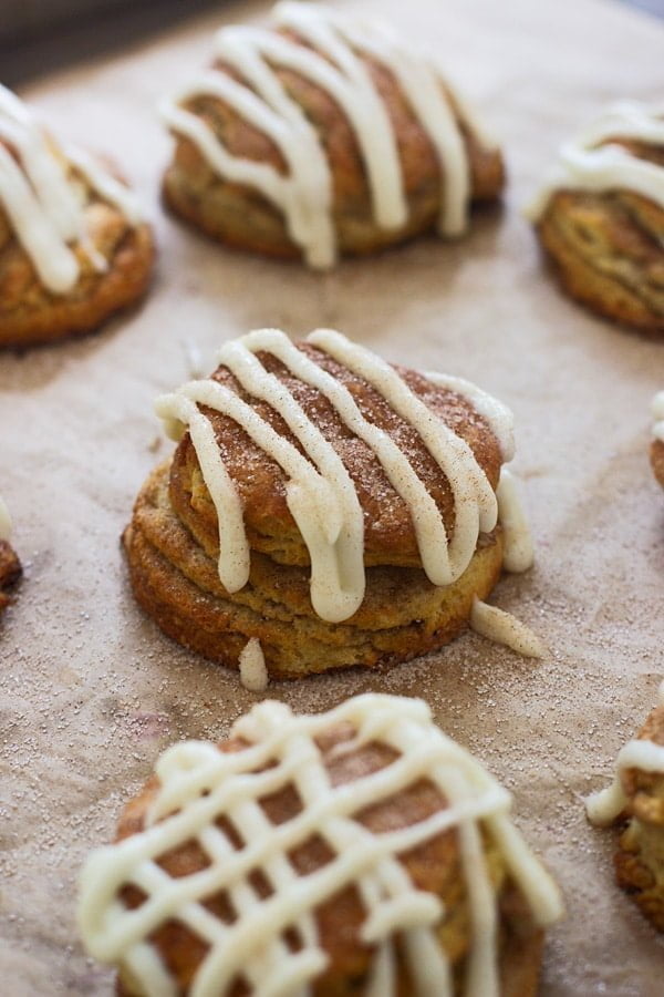 Cinnamon Roll Butterilk Biscuits - Super flaky layers of dough sprinkled with cinnamon and sugar and drenched in cream cheese frosting.