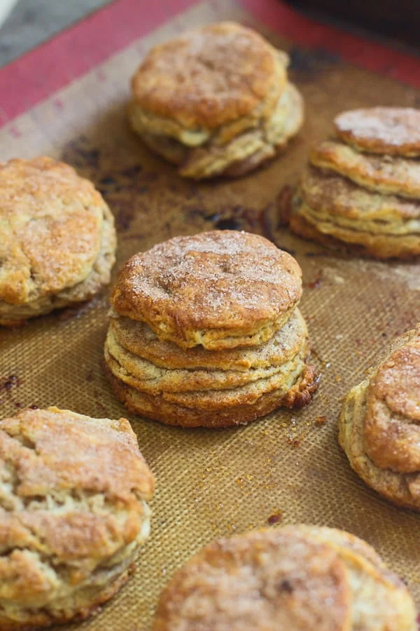Cinnamon Roll Butterilk Biscuits - Super flaky layers of dough sprinkled with cinnamon and sugar and drenched in cream cheese frosting.