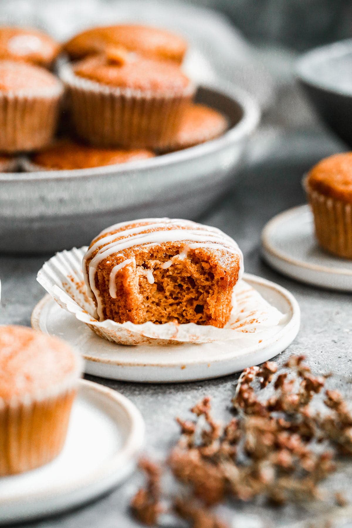 Our Easy Pumpkin Muffin Recipe is full of pumpkin flavor with notes of apple cider and the most tender, moist interior. Hands down the best pumpkin muffin recipe you'll make this fall! We drizzle the tops with a two-ingredient apple cider glaze but these are just as scrumptious plain.&nbsp;
