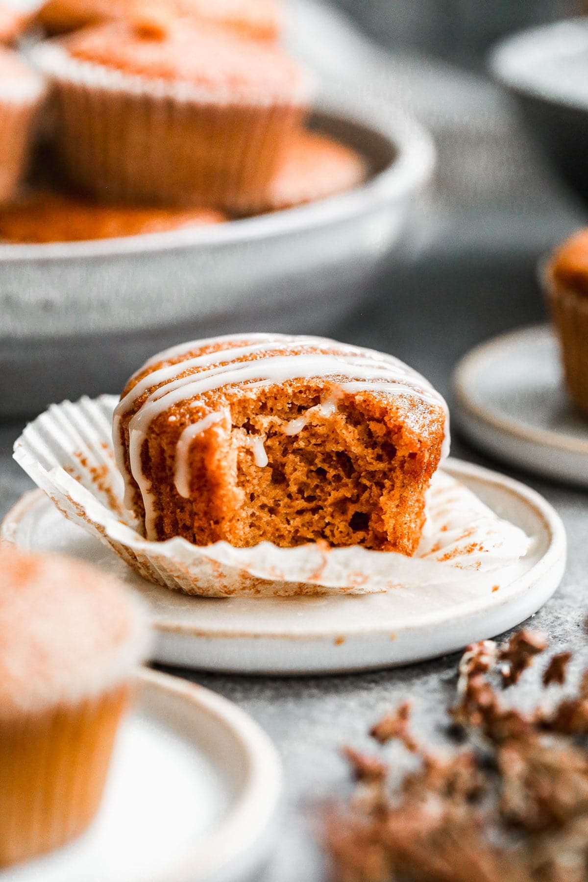 Our Easy Pumpkin Muffin Recipe is full of pumpkin flavor with notes of apple cider and the most tender, moist interior. Hands down the best pumpkin muffin recipe you'll make this fall! We drizzle the tops with a two-ingredient apple cider glaze but these are just as scrumptious plain. 