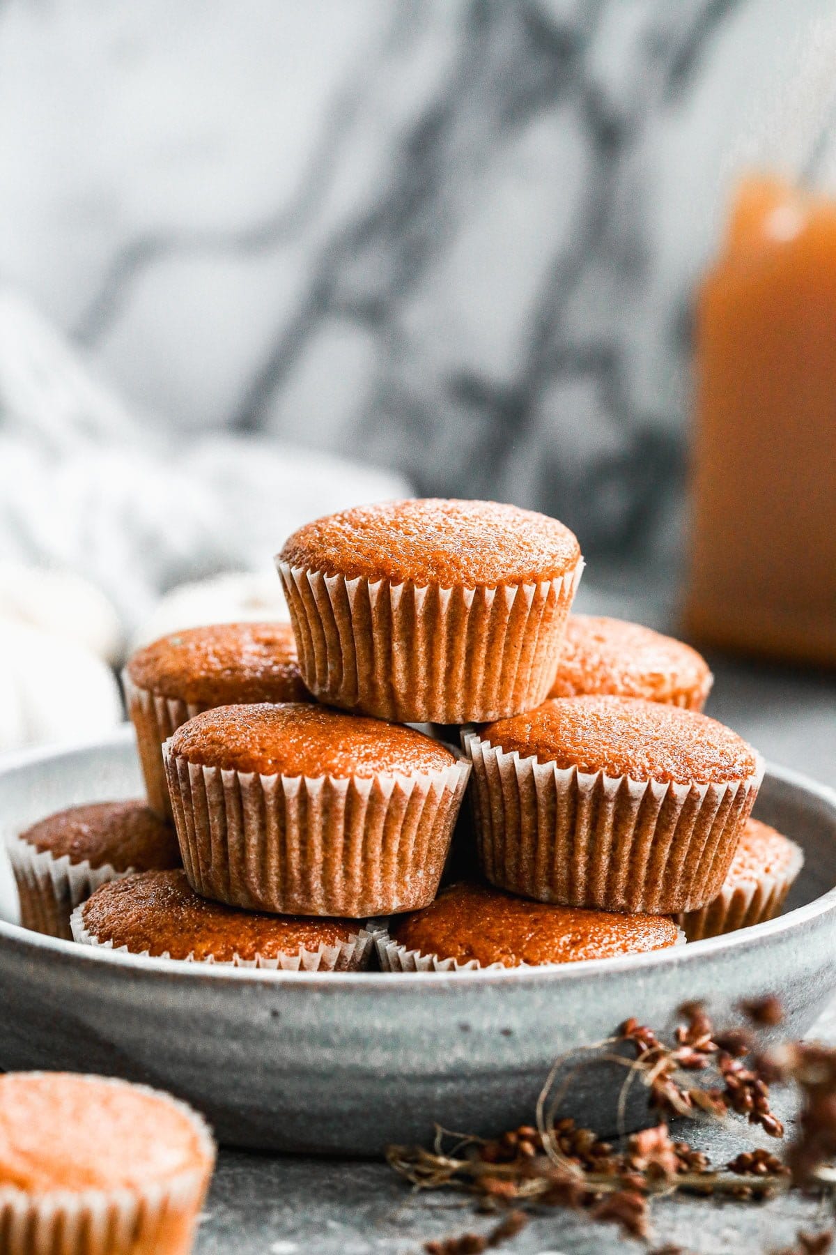 Our Easy Pumpkin Muffin Recipe is full of pumpkin flavor with notes of apple cider and the most tender, moist interior. Hands down the best pumpkin muffin recipe you'll make this fall! We drizzle the tops with a two-ingredient apple cider glaze but these are just as scrumptious plain.&nbsp;