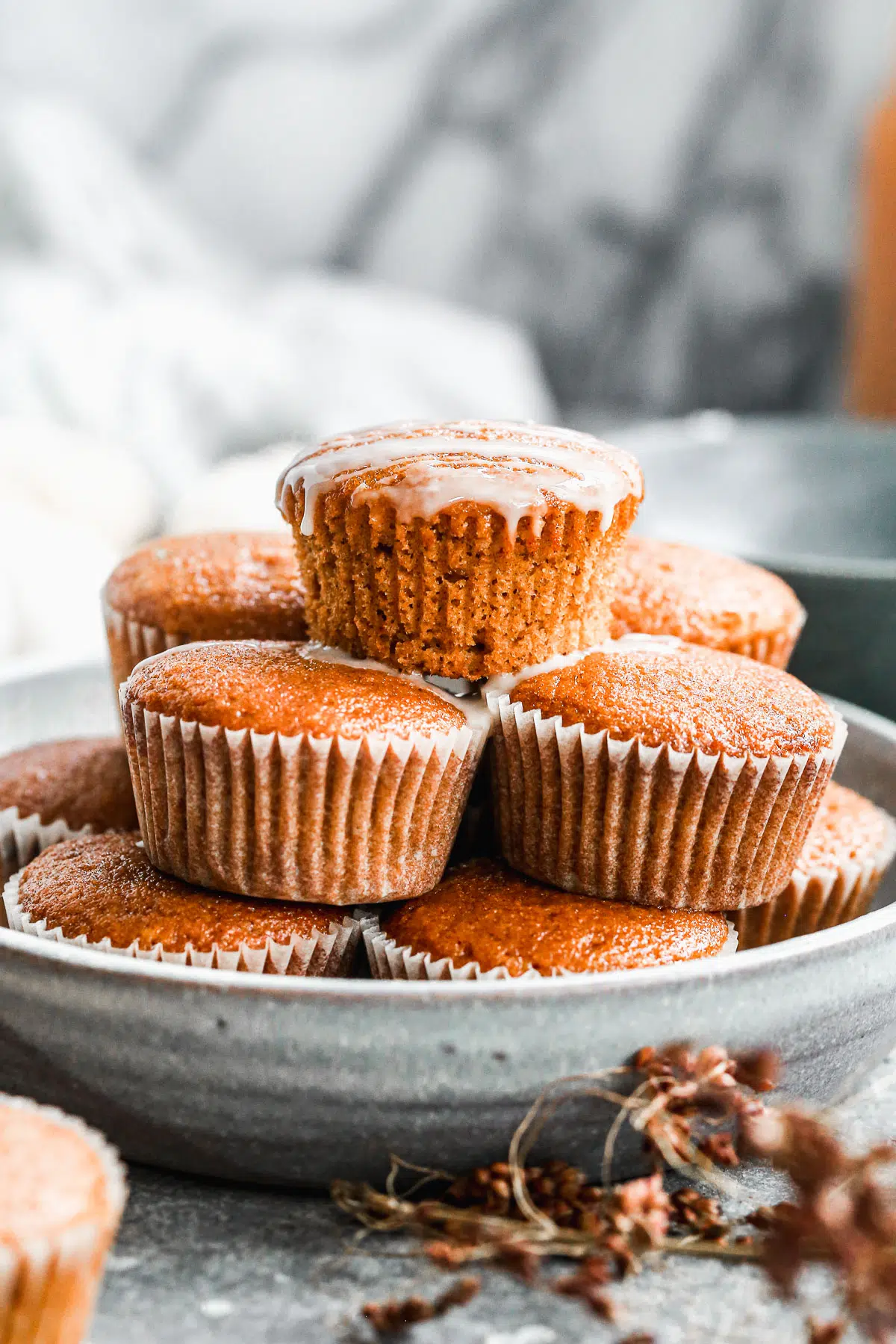 Our Easy Pumpkin Muffin Recipe is full of pumpkin flavor with notes of apple cider and the most tender, moist interior. Hands down the best pumpkin muffin recipe you'll make this fall! We drizzle the tops with a two-ingredient apple cider glaze but these are just as scrumptious plain.&nbsp;