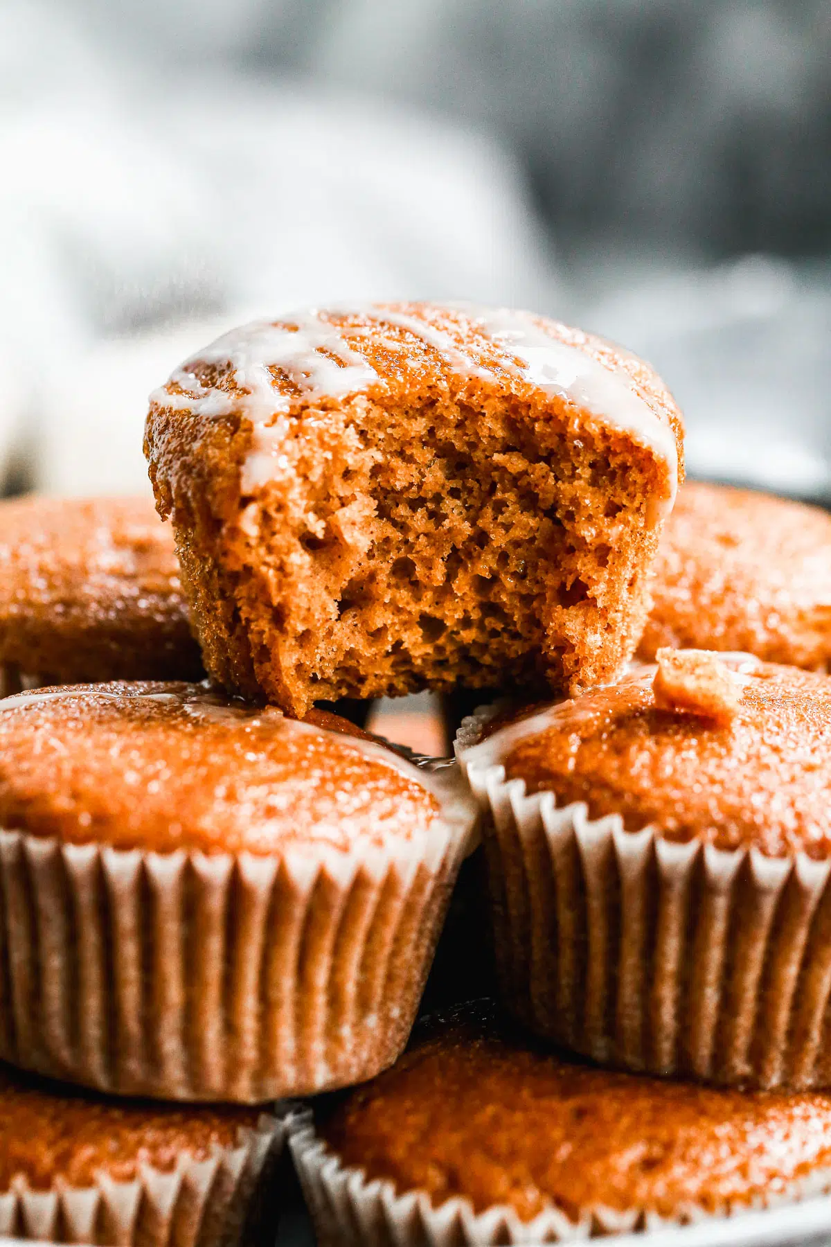 Our Easy Pumpkin Muffin Recipe is full of pumpkin flavor with notes of apple cider and the most tender, moist interior. Hands down the best pumpkin muffin recipe you'll make this fall! We drizzle the tops with a two-ingredient apple cider glaze but these are just as scrumptious plain.&nbsp;