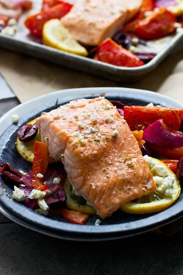 Easy One Pan Greek Salmon with roasted tomatoes, lemon, olives and feta cheese