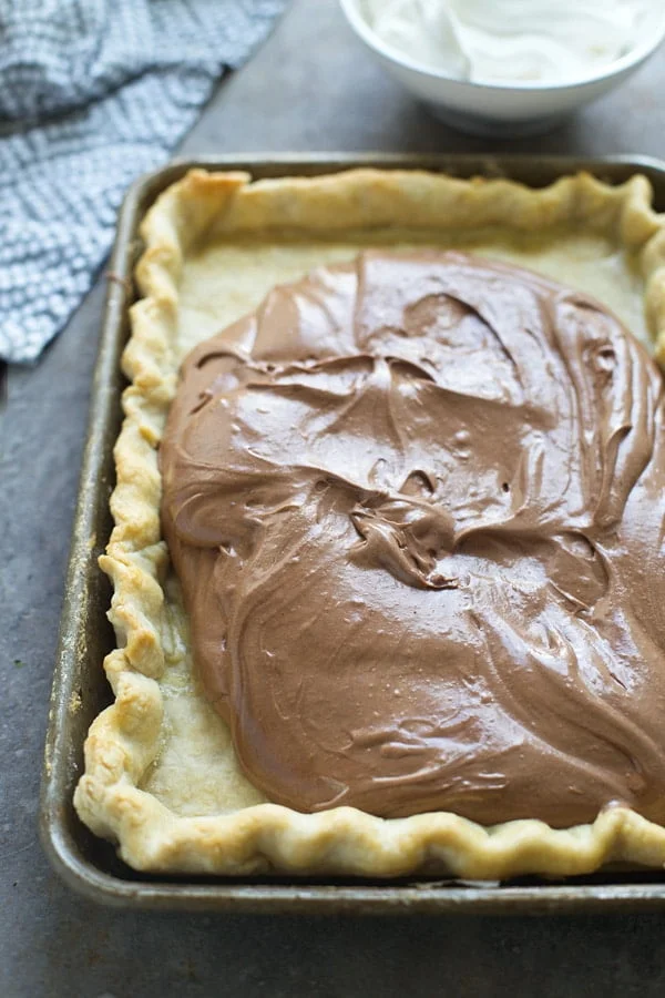 Pouring French Silk filling into a homemade buttery crust