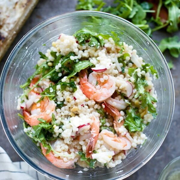 Tossing couscous and shrimp salad