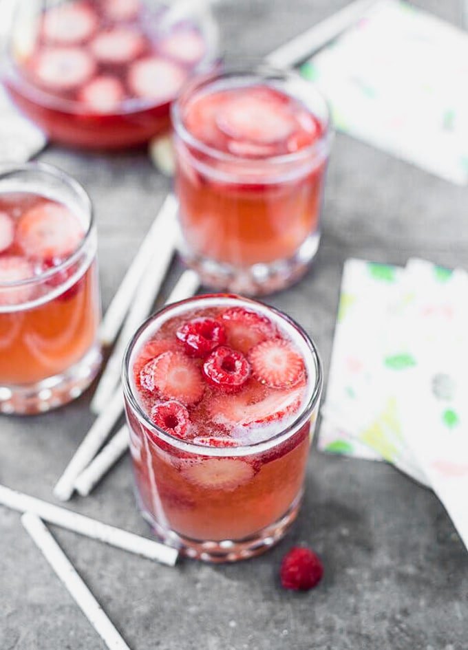 Rosé Sangria is the only cocktail you'll want to drink all summer long. Packed with fresh strawberries, dry rosé, and sparkling water, this is light and refreshing, effervescent, and perfect for a crowd!