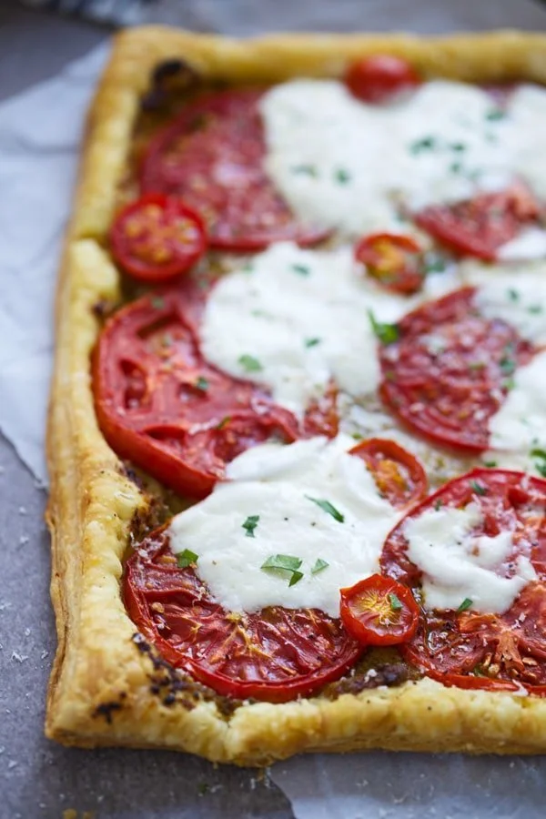 Tomatoes, burrata and pesto on puff pastry
