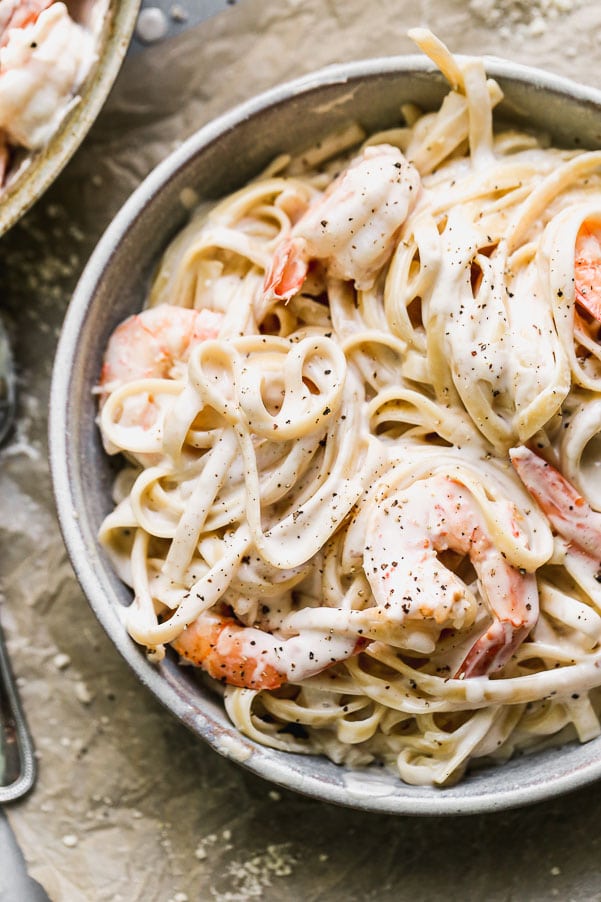 This 5-Ingredient Shrimp Alfredo is THE BEST Alfredo you'll ever taste. It's a cinch to make, takes under 30 minutes and tastes even better than anything you'll find at a restaurant. All you need is fettuccine noodles, heavy cream, good parmesan cheese, shrimp, and a little bit of butter! 