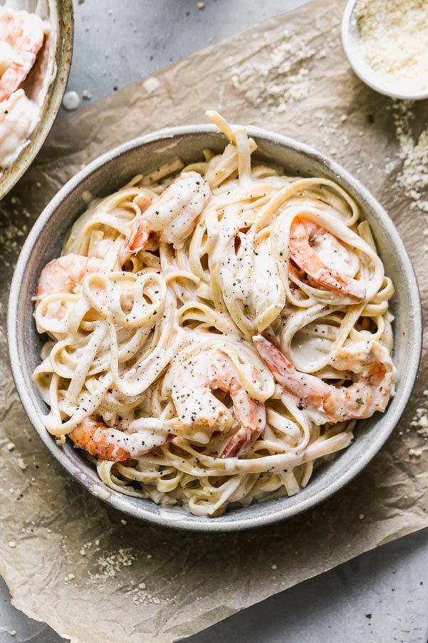 This 5-Ingredient Shrimp Alfredo is THE BEST Alfredo you'll ever taste. It's a cinch to make, takes under 30 minutes and tastes even better than anything you'll find at a restaurant. All you need is fettuccine noodles, heavy cream, good parmesan cheese, shrimp, and a little bit of butter! 