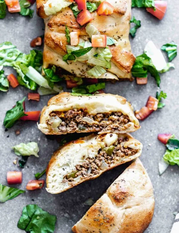 Cheeseburger Stromboli: A super flavorful, cheesy beef filling studded with dill pickles, sweet onions and zippy mustard. Wrap it up in a store-bought pizza crust, bake and serve! SO good.
