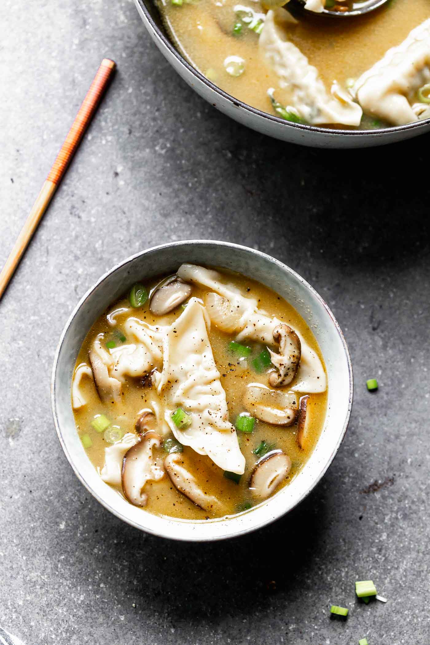 This Easy Wonton Soup takes a shortcut with frozen dumplings but doesn't take any shortcuts on flavor. The broth is packed with only a few ingredients - ginger, garlic, sesame and soy - but is SO flavorful. Earthy shiitake mushrooms and crisp green onions round it out! 