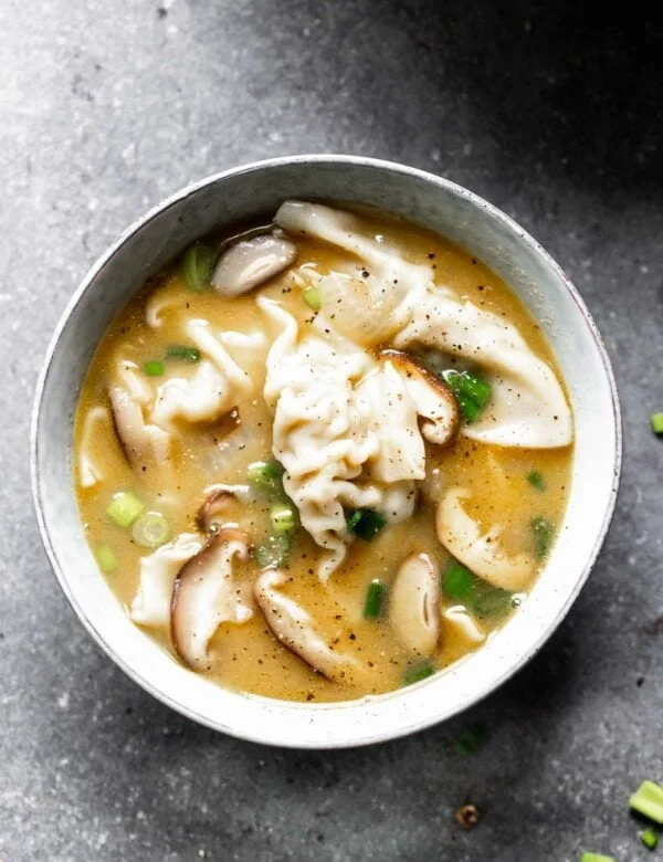 This Easy Wonton Soup takes a shortcut with frozen dumplings but doesn't take any shortcuts on flavor. The broth is packed with only a few ingredients - ginger, garlic, sesame and soy - but is SO flavorful. Earthy shiitake mushrooms and crisp green onions round it out!