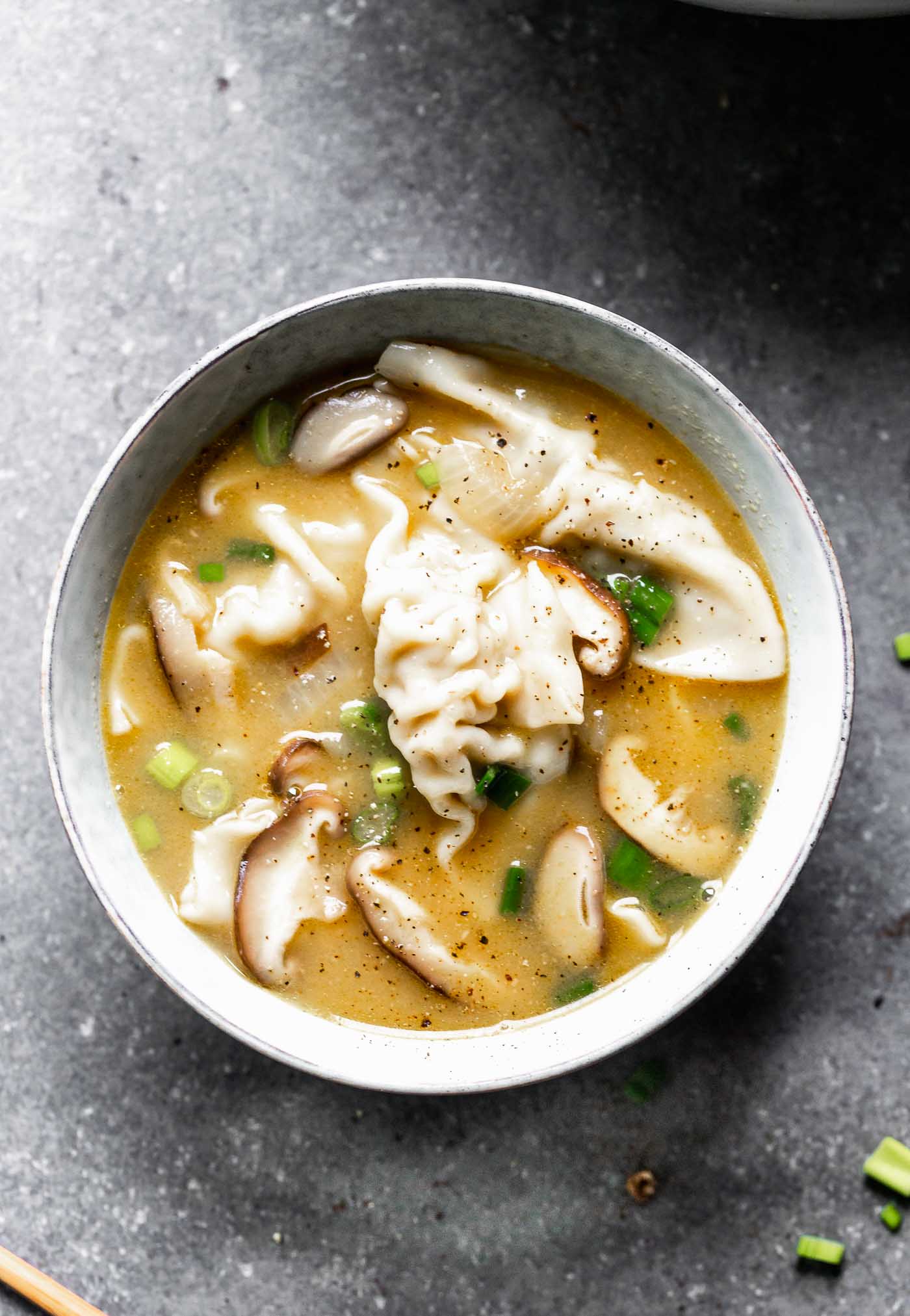 This Easy Wonton Soup takes a shortcut with frozen dumplings but doesn't take any shortcuts on flavor. The broth is packed with only a few ingredients - ginger, garlic, sesame and soy - but is SO flavorful. Earthy shiitake mushrooms and crisp green onions round it out! 