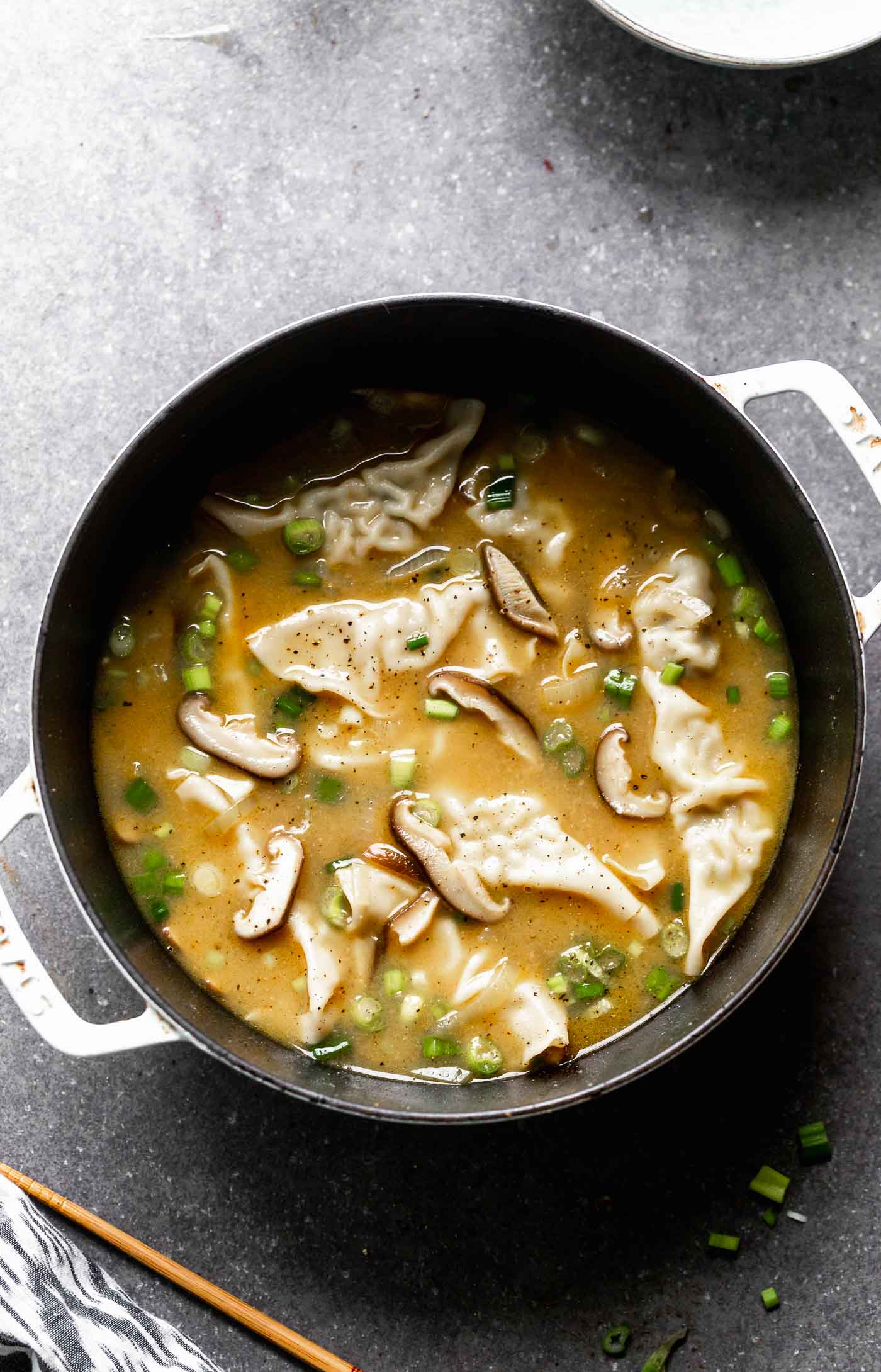 This Easy Wonton Soup takes a shortcut with frozen dumplings but doesn't take any shortcuts on flavor. The broth is packed with only a few ingredients - ginger, garlic, sesame and soy - but is SO flavorful. Earthy shiitake mushrooms and crisp green onions round it out! 