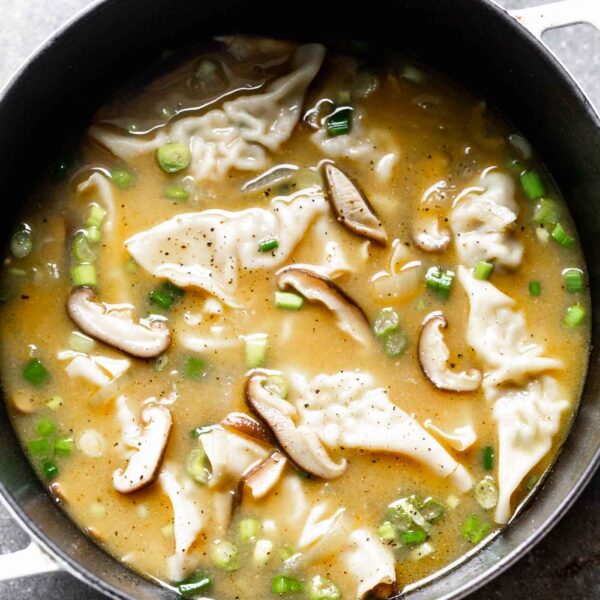This Easy Wonton Soup takes a shortcut with frozen dumplings but doesn't take any shortcuts on flavor. The broth is packed with only a few ingredients - ginger, garlic, sesame and soy - but is SO flavorful. Earthy shiitake mushrooms and crisp green onions round it out!