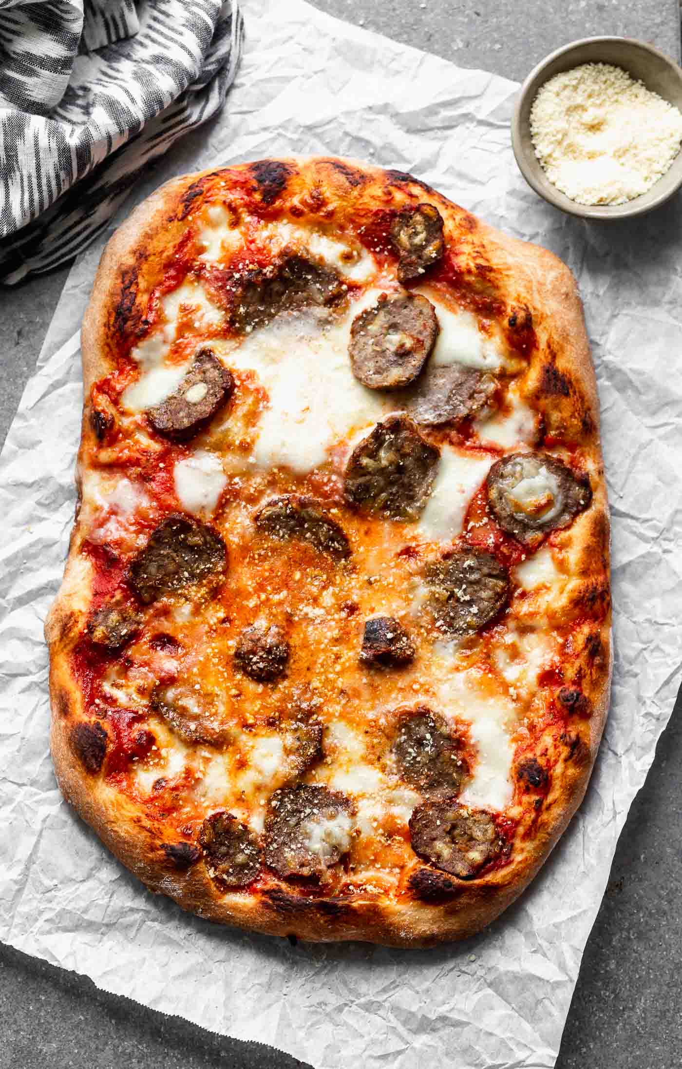 Tender, flavor-packed meatballs are sliced and layered with fresh mozzarella, parmesan cheese and a spaghetti and a meatball-inspired marinara sauce, in the&nbsp;<strong>Best Meatball Pizza Recipe.</strong> Topped with a fresh dusting of parmesan cheese, this simple pizza will become a new favorite! Perfect for leftover meatballs!
