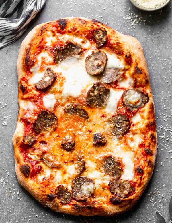 Tender, flavor-packed meatballs are sliced and layered with fresh mozzarella, parmesan cheese and a spaghetti and a meatball-inspired marinara sauce, in the Best Meatball Pizza Recipe. Topped with a fresh dusting of parmesan cheese, this simple pizza will become a new favorite! Perfect for leftover meatballs!