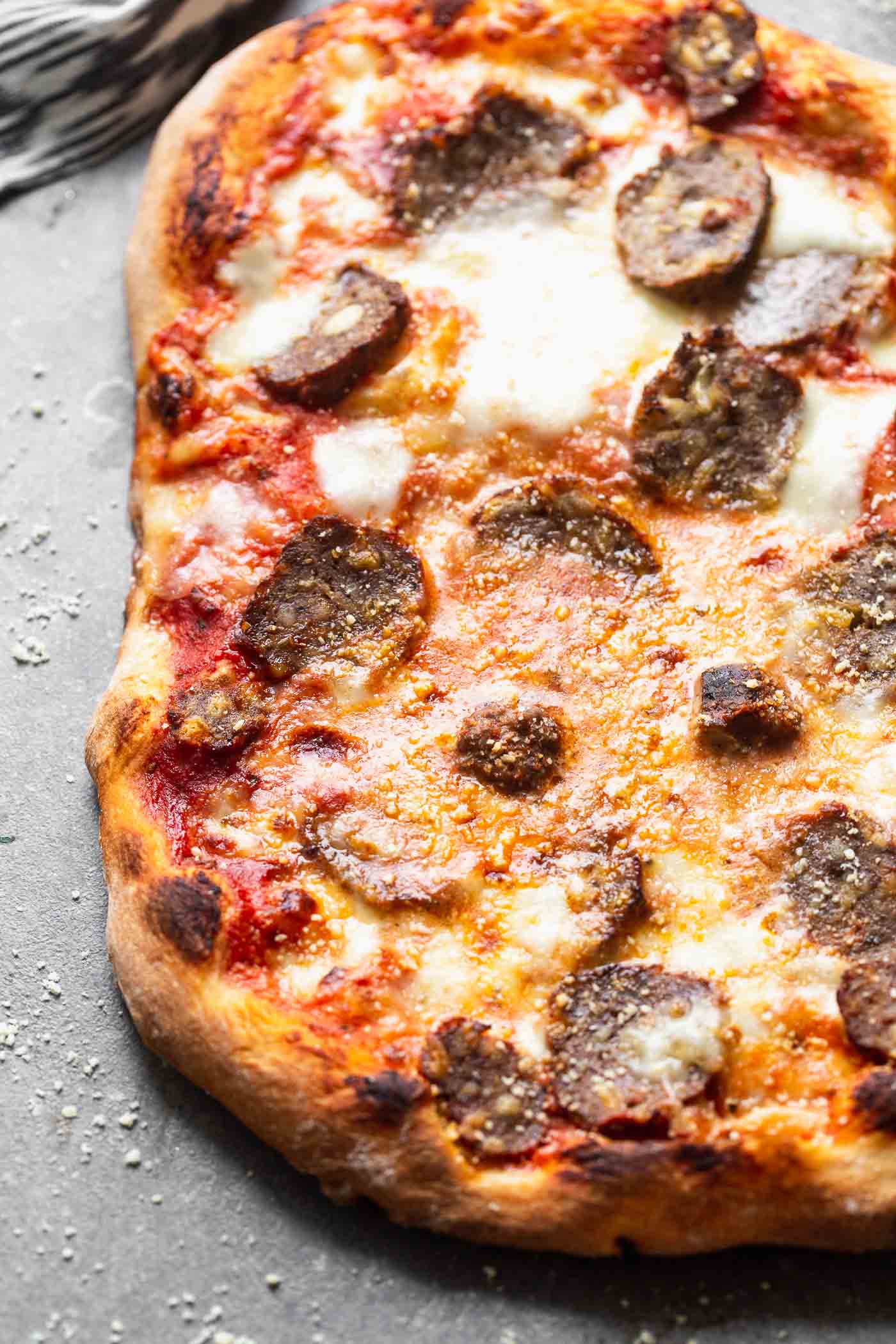 Tender, flavor-packed meatballs are sliced and layered with fresh mozzarella, parmesan cheese and a spaghetti and a meatball-inspired marinara sauce, in the&nbsp;<strong>Best Meatball Pizza Recipe.</strong> Topped with a fresh dusting of parmesan cheese, this simple pizza will become a new favorite! Perfect for leftover meatballs!