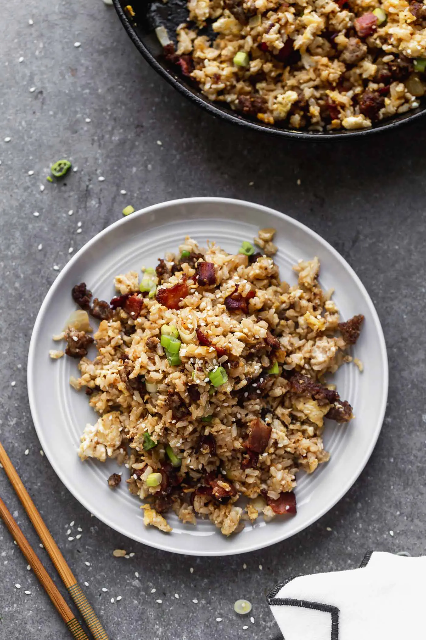 This Breakfast Fried Rice Recipe is packed with salty bacon and sausage, a light soy sauce, oniob, garlic, and plenty of hearty scrambled eggs. 