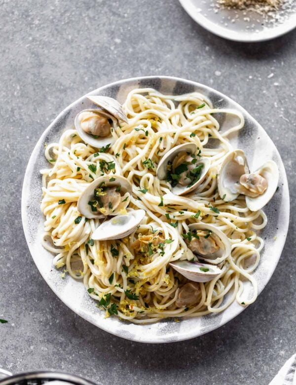 If you're a fan of light, ever-so-subtle seafood pasta, then this Easy Linguini with Clams is right in your wheelhouse. With a lemon and garlic-forward sauce, hints of red pepper flake, and delicate shallots, this meal has quickly become one of our favorites. It's also perfect for entertaining, which we love.