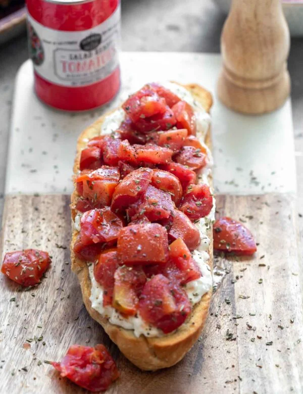 Crispy French bread halves are seasoned with salt and pepper and baked until golden and crisp. They're brushed with garlic, then smothered with creamy whipped ricotta and topped with simply seasoned tomatoes. Serve with a crisp salad or as an appetizer!
