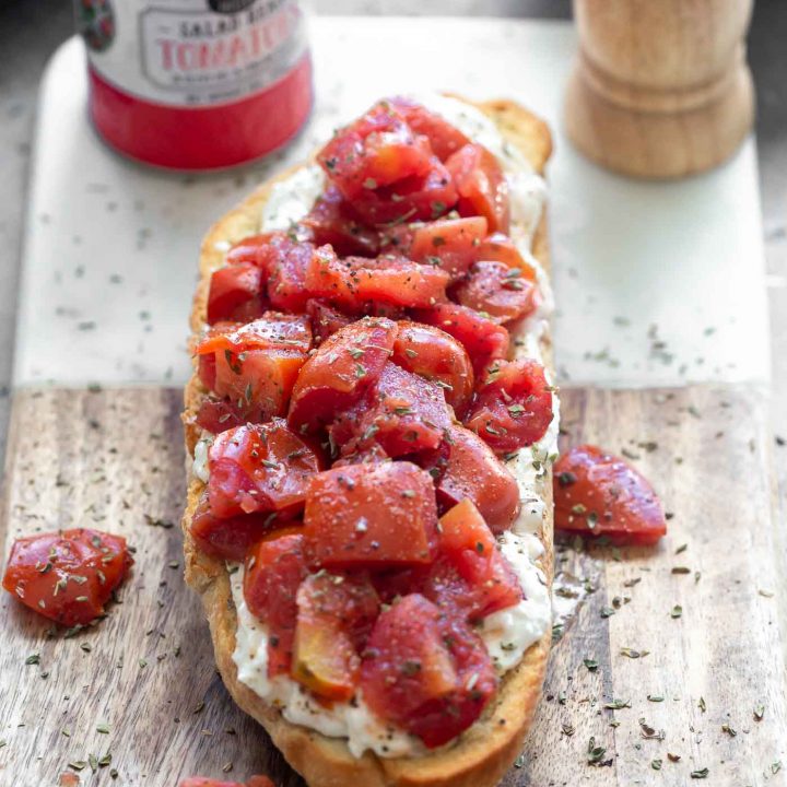 Crispy French bread halves are seasoned with salt and pepper and baked until golden and crisp. They're brushed with garlic, then smothered with creamy whipped ricotta and topped with simply seasoned tomatoes. Serve with a crisp salad or as an appetizer!