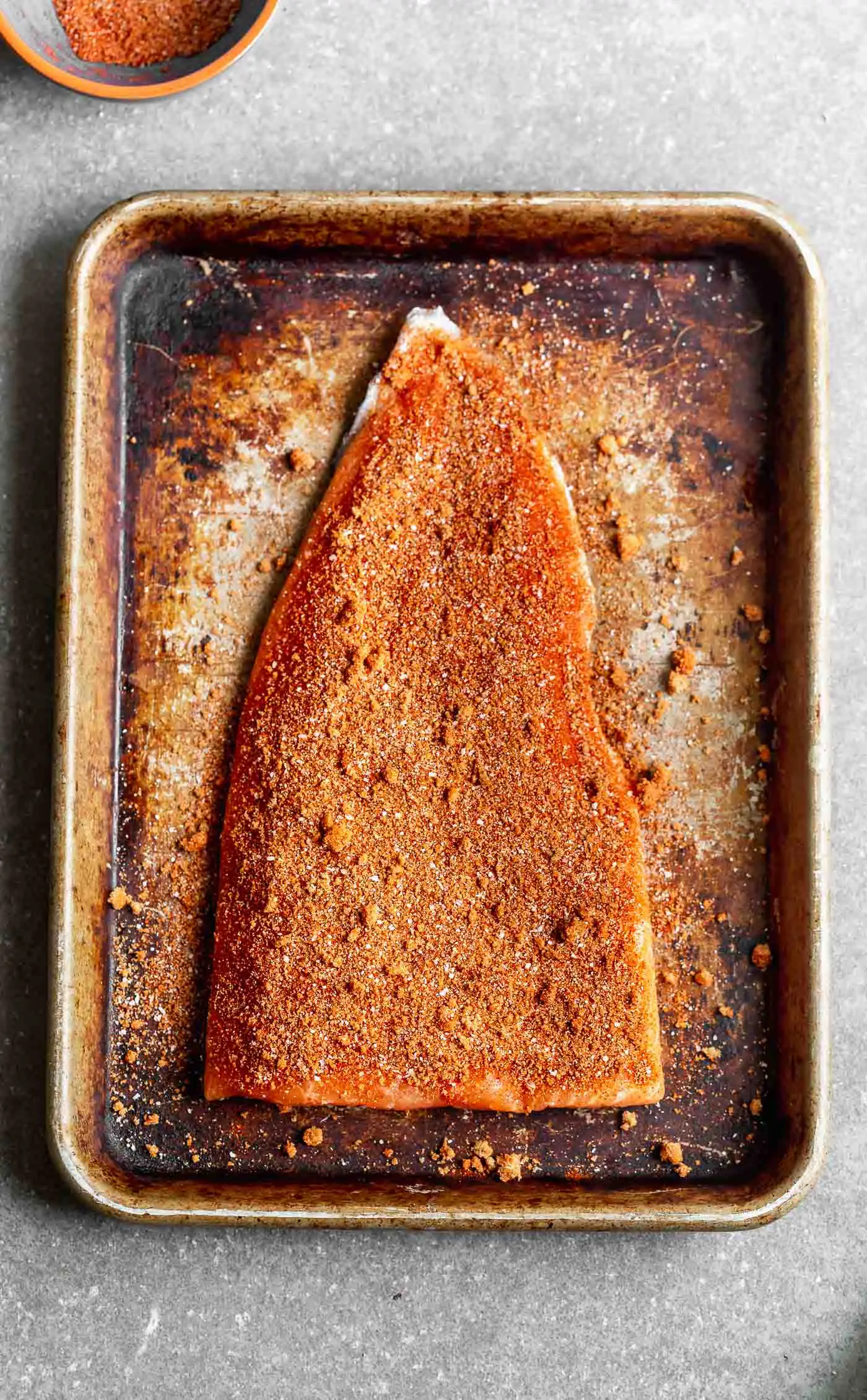 Press the rub into the side of the salmon.