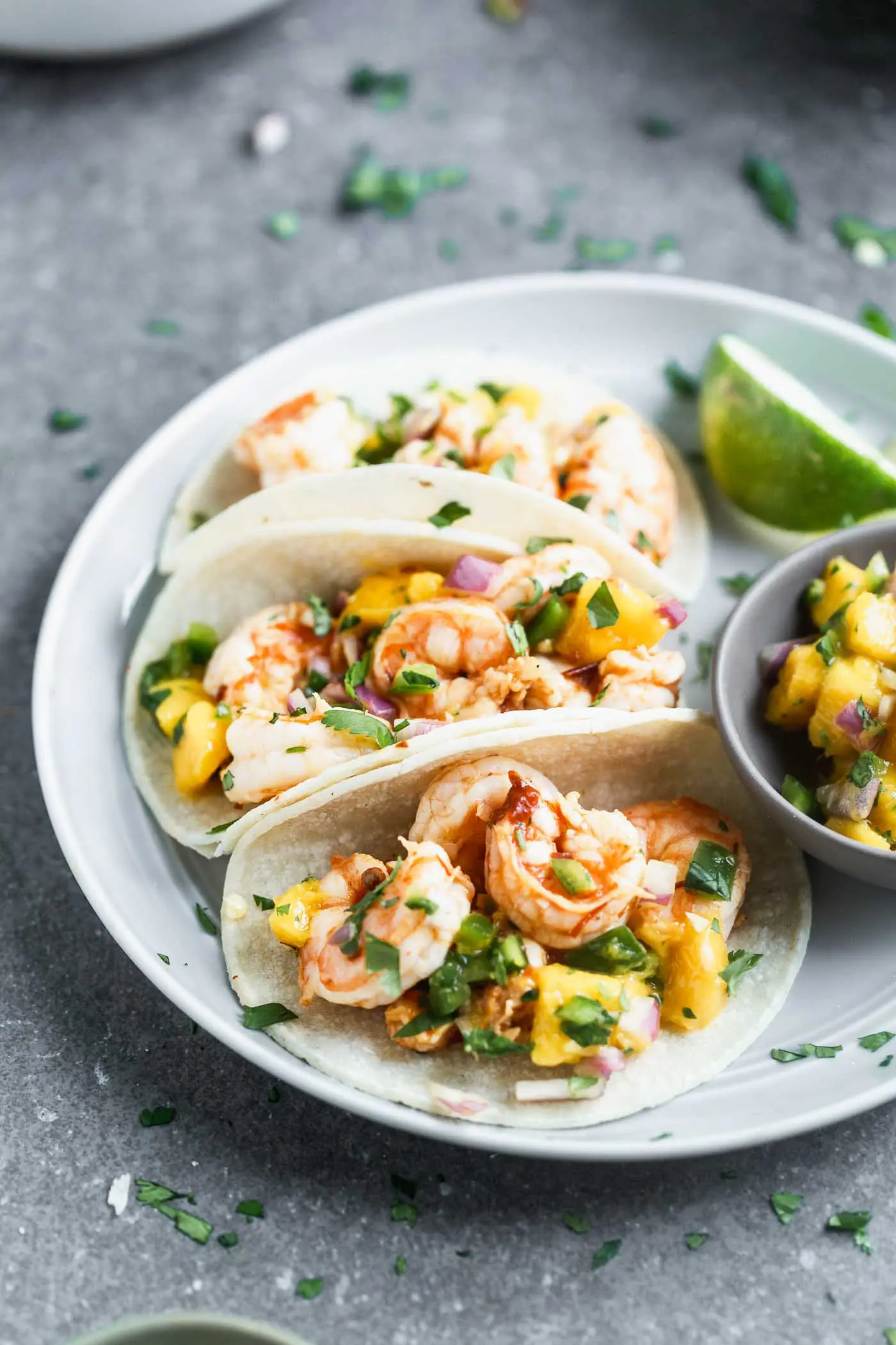 These&nbsp;Easy Chipotle Shrimp Tacos with Mango Salsa are perfect for breezy summer lunches, healthy dinners, or any kind of celebration. Plump shrimp are flavored with chipotle peppers, lime juice, and honey, baked and nestled into corn tortillas (or lettuce wraps!). Each taco is topped off with a quick homemade mango salsa, a little bit of cilantro, and ready to be served!