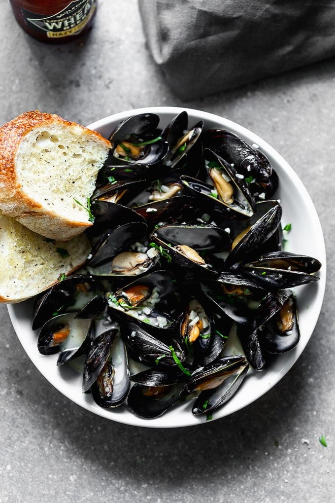 These 5-Ingredient Steamed Beer Mussels are the easiest, most delicious was to prepare mussels! All you need is beer, garlic, a little bit of butter, heavy cream, and of course mussels! We also talk about how to store, clean, and prepare them so they're perfect every time!&nbsp;