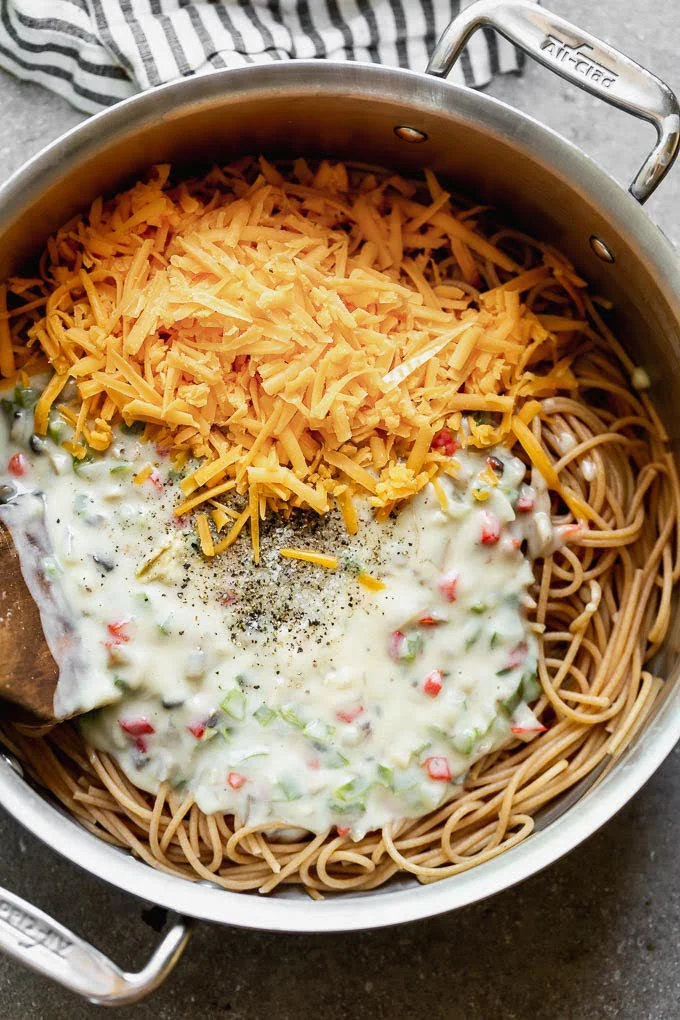 Add spaghetti, cream of mushroom sauce, cheese, chicken, and pimentos together. 