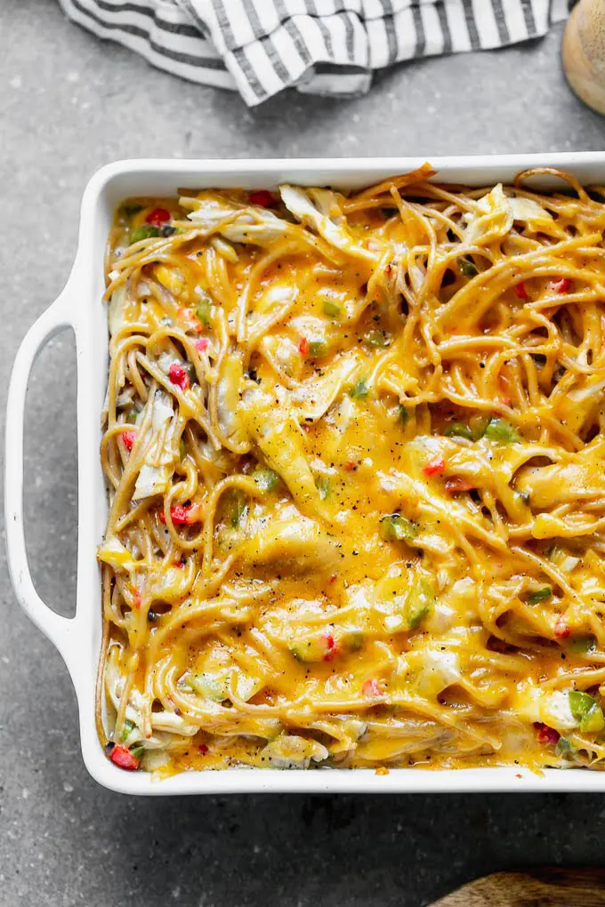Healthy Chicken Spaghetti is an updated version of my favorite cheese chicken spaghetti from childhood, and SO delicious! Instead of using canned cream of mushroom, I make an easy homemade version, and mix it with sautéed veggies, whole-wheat spaghetti, plenty of shredded chicken, and of course, lots of cheese. The perfect back-to-school meal!