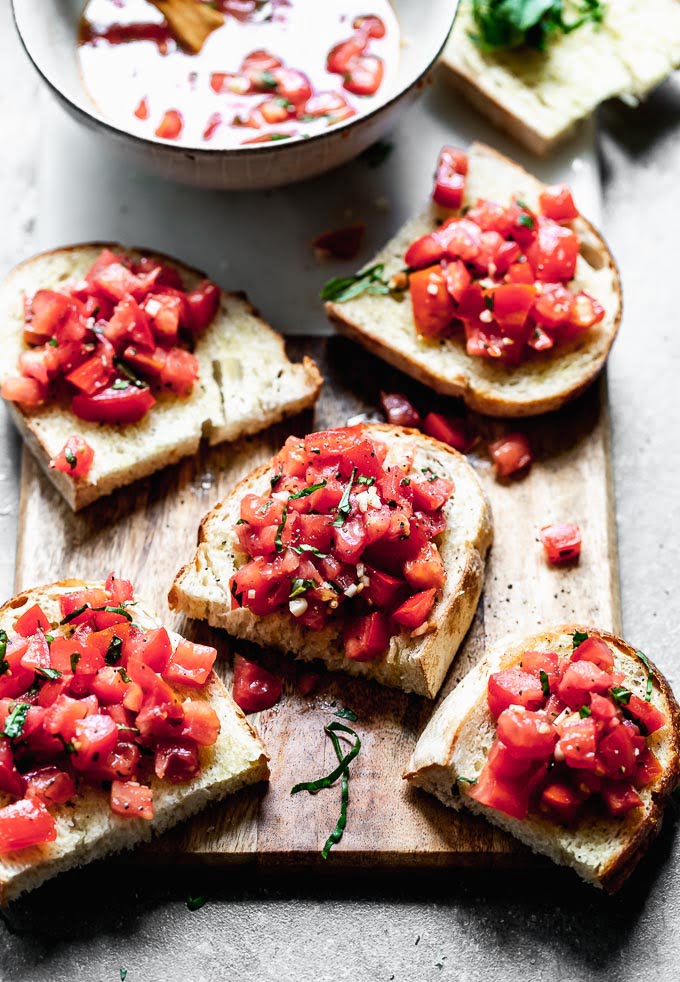 Tomato Basil Bruschetta is a classic Italian appetizer, and something everyone should make when tomatoes are at their peak. This version is completely authentic with just tomatoes, basil, olive oil, and a little bit of salt and pepper to season the tomatoes. &nbsp;It's served with crusty Italian bread, and that's it!